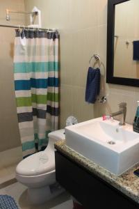a bathroom with a sink and a toilet and a shower at Maya Vacanze Playa Quinta B&B in Playa del Carmen +33 photos