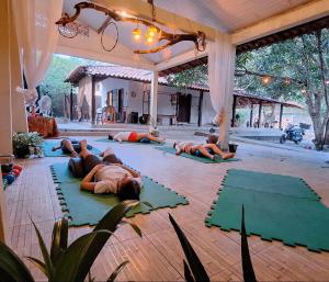 a group of people laying on the floor in a yoga class at TRIBUS Hospedagem e Terapias in Alter do Chao