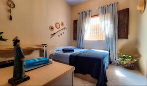 a bedroom with a bed and a desk and a window at TRIBUS Hospedagem e Terapias in Alter do Chao +16 photos