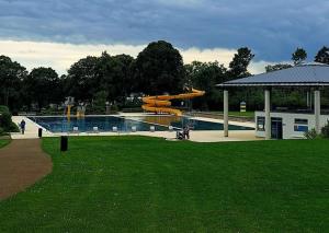a swimming pool with a slide in a park at Albferienhaus Schaette in Giengen an der Brenz