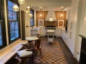 a kitchen with a table and some chairs and a table at The Saltburn Townhouse in Saltburn-by-the-Sea
