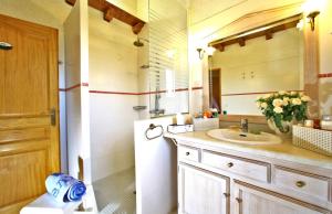 a bathroom with a sink and a white refrigerator at Gite Four De Mon Père in Salignac Eyvigues +11 photos