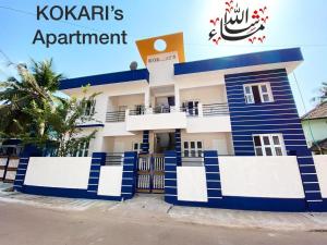 a blue and white building with the words kazakh apartment at AL MANAL K-002 Premium 2BHK Retreat in Bhatkal