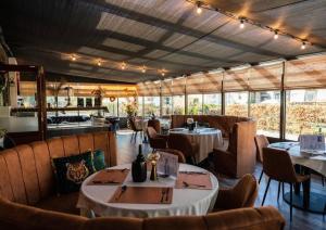 a restaurant with tables and chairs in a room at 't Haasnestje in Harderwijk