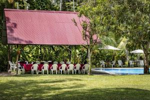 a group of tables and chairs next to a pool at Fundo Baños in Tarapoto