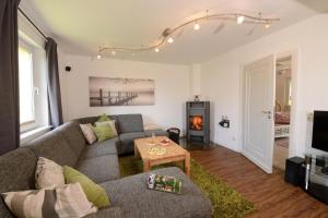 a living room with a couch and a fireplace at Ruhiges Ferienhaus In Lommersdorf Mit Garten in Blankenheim