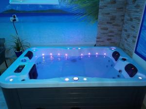 a jacuzzi tub with lights in a bathroom at Ferienwohnung Maaridyll In Schalkenmehren in Schalkenmehren