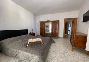 a bedroom with a bed with a wooden table on it at dimora virginia in Matera