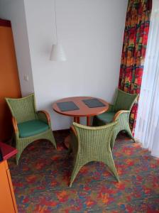 three chairs and a table in a room at Dream Apartment in Rötz
