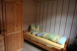a bed with two pillows on it in a room at Wohnung In Ilfeld Mit Grill Und Garten in Harztor