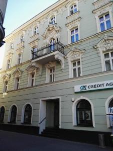 a white building with a balcony on top of it at Rynkowy in Rybnik
