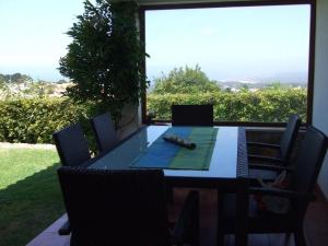 a table and chairs on a patio with a view at Casa Do Moinho in Colares