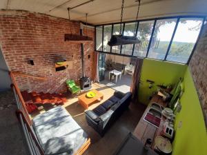 an overhead view of a living room with a brick wall at The Regiment Self Catering Accommodation in Welgemoed