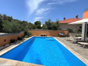 a swimming pool in the backyard of a house at Villa Summer Escape In Barbat Mit Garten Und Aussicht in Barbat na Rabu