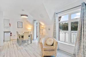 uma cozinha e sala de jantar com uma mesa e uma janela em 6 Rushbrooke Hotel Apartments Cobh County Cork em Cobh