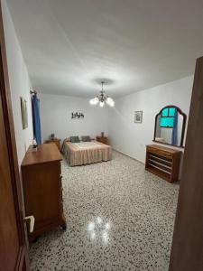 a bedroom with a bed and a table and a mirror at Casa grande en Garachico centro in Garachico