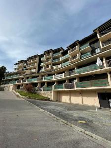 a large apartment building on the side of a street at Studio accueillant avec vue montagne à Font-Romeu in Font-Romeu +15 photos
