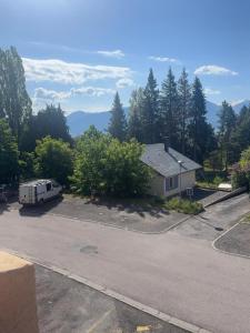 a rv parked in a parking lot next to a house at Studio accueillant avec vue montagne à Font-Romeu in Font-Romeu