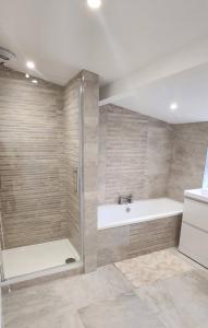 Un baño con ducha, bañera y lavabo. en Cwm Uchaf Holiday Home, hot tub and horse view!, en Abergele 15 fotos más