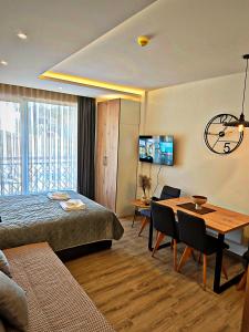 a bedroom with a bed and a table and a dining room at Harmony, Residence Hill A85 in Kopaonik