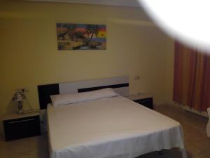 Postel nebo postele na pokoji v ubytování Hostal Imperial