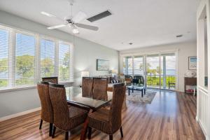 a dining room and living room with a table and chairs at Cedars East #822 in Longboat Key