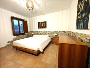 a bedroom with a bed and a wooden dresser at Lakefront with garden in Oria