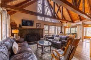 a living room with leather furniture and a fireplace at Bear Valley in Fleetwood