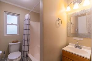 a bathroom with a toilet and a sink and a mirror at Bear Valley in Fleetwood +48 photos