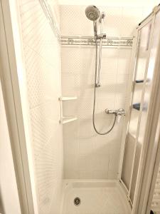a shower with a glass door in a bathroom at Lakefront with garden in Oria +16 photos