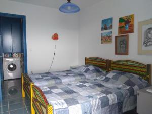 a bedroom with a bed with a checkered blanket at Cottage in Tiros