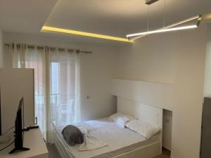 a bedroom with a bed and a desk with a computer at Shengjin apartaments in Lezhë +58 photos