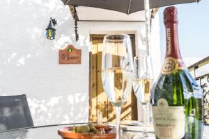 a bottle of wine sitting on a table with a glass at Casa El Limonero, Landhaus Mit Aussicht in Dúrcal +21 photos