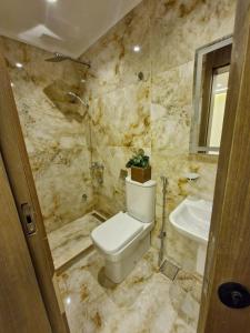 a bathroom with a toilet and a sink at Gardinia City Apartment in Cairo +10 photos