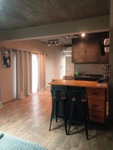 a kitchen with a island in the middle of a room at Departamento Perico Jujuy in Perico