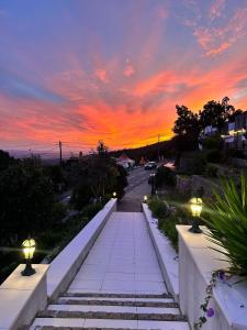 a pathway leading down a street at sunset at Aqua Vista Monchique Hôtel in Monchique +76 photos
