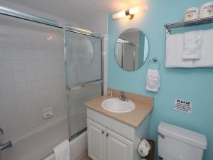 a bathroom with a shower and a sink and a mirror at Silver Sands #232 in Longboat Key +25 photos
