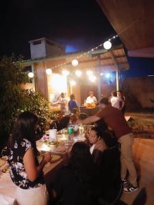 a group of people sitting around a table at a party at Departamento Perico Jujuy in Perico