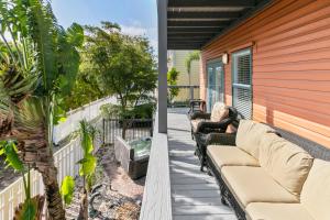 a woman sitting on the porch of a house at Beach Breeze East in Bradenton Beach