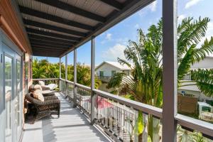 a balcony with a view of a house at Beach Breeze East in Bradenton Beach +29 photos