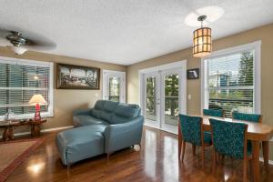 a living room with a blue couch and a table at Beach Breeze West in Bradenton Beach