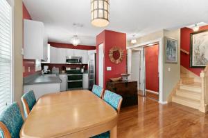 a kitchen and dining room with a wooden table and chairs at Beach Breeze West in Bradenton Beach