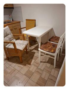 a kitchen with a table and two chairs and a table at Apartment for recreation in the district of Děčín 