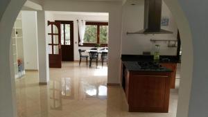 a kitchen with a stove and a dining room at Ferienhaus In Pedruscada Mit Privatem Pool in Cala Ratjada