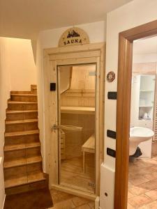 a room with a staircase and a door to a room with a bed at Casetta Zoe - Private Sauna in Margone +34 photos
