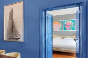 a bedroom with blue walls and a bed with a sailboat at Ziggy Blues in Arrecife +12 photos