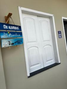 a white door with a sign in front of it at ORLA FLAT - Apartamento 02 in Bragança +1 photo