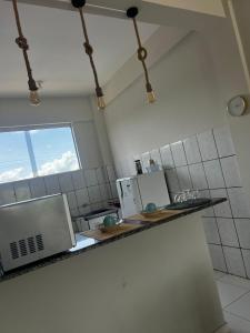 a kitchen with a counter and a window in it at ORLA FLAT - Apartamento 02 in Bragança