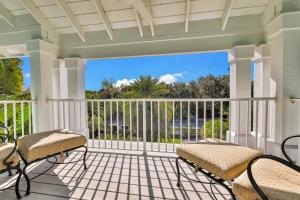 een veranda met twee stoelen en een balkon bij Aqua Bay in Longbeach