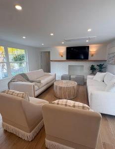 un soggiorno con mobili bianchi e un camino di Casa Poinsetta a Longbeach